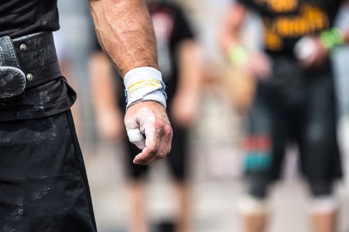 Closeup of athlete hand before his attempt to lift barbell