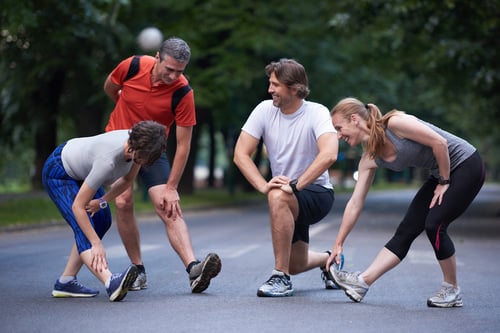 jogging people group stretching in park before training